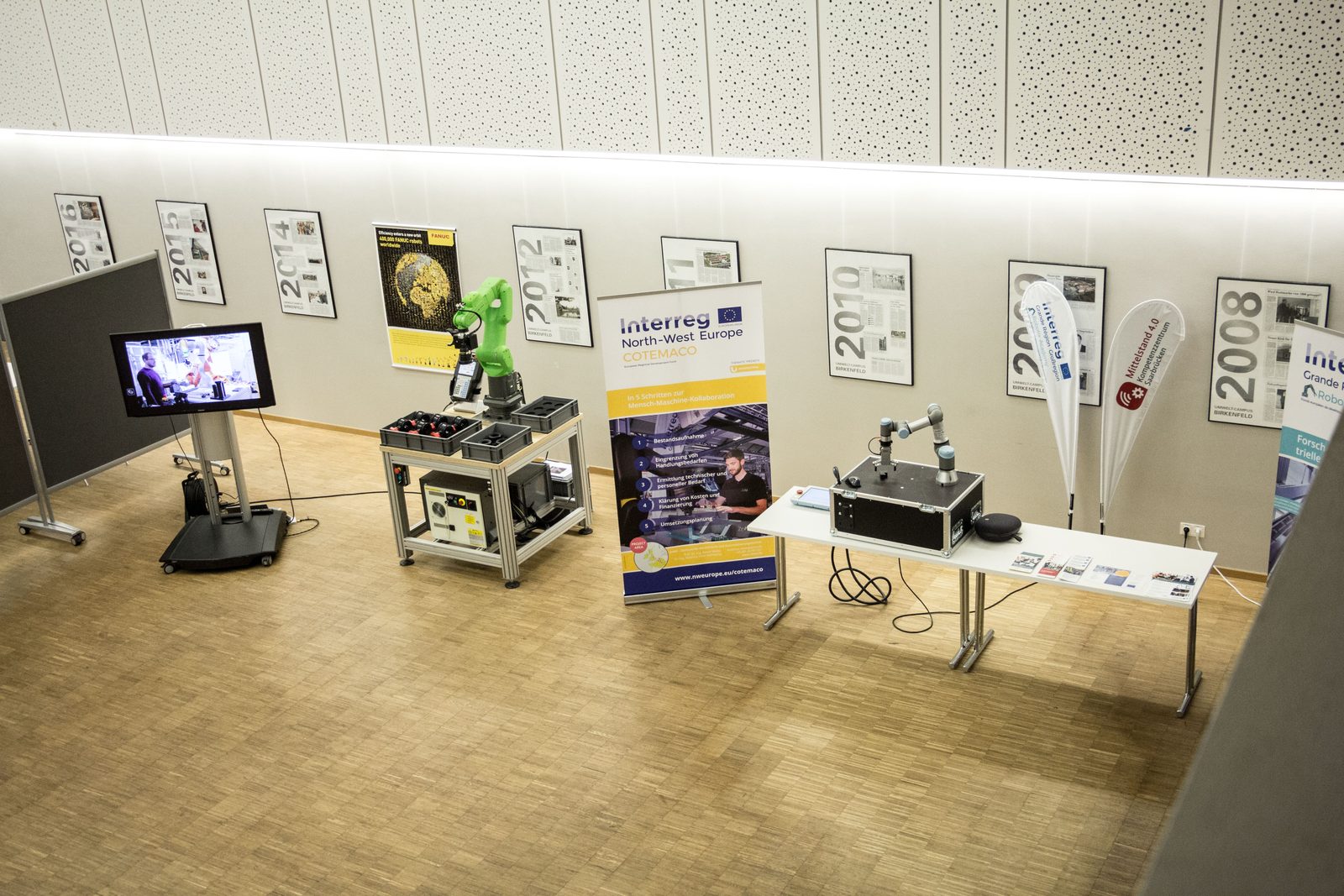 Robots and demonstrators on display in the exhibition area.